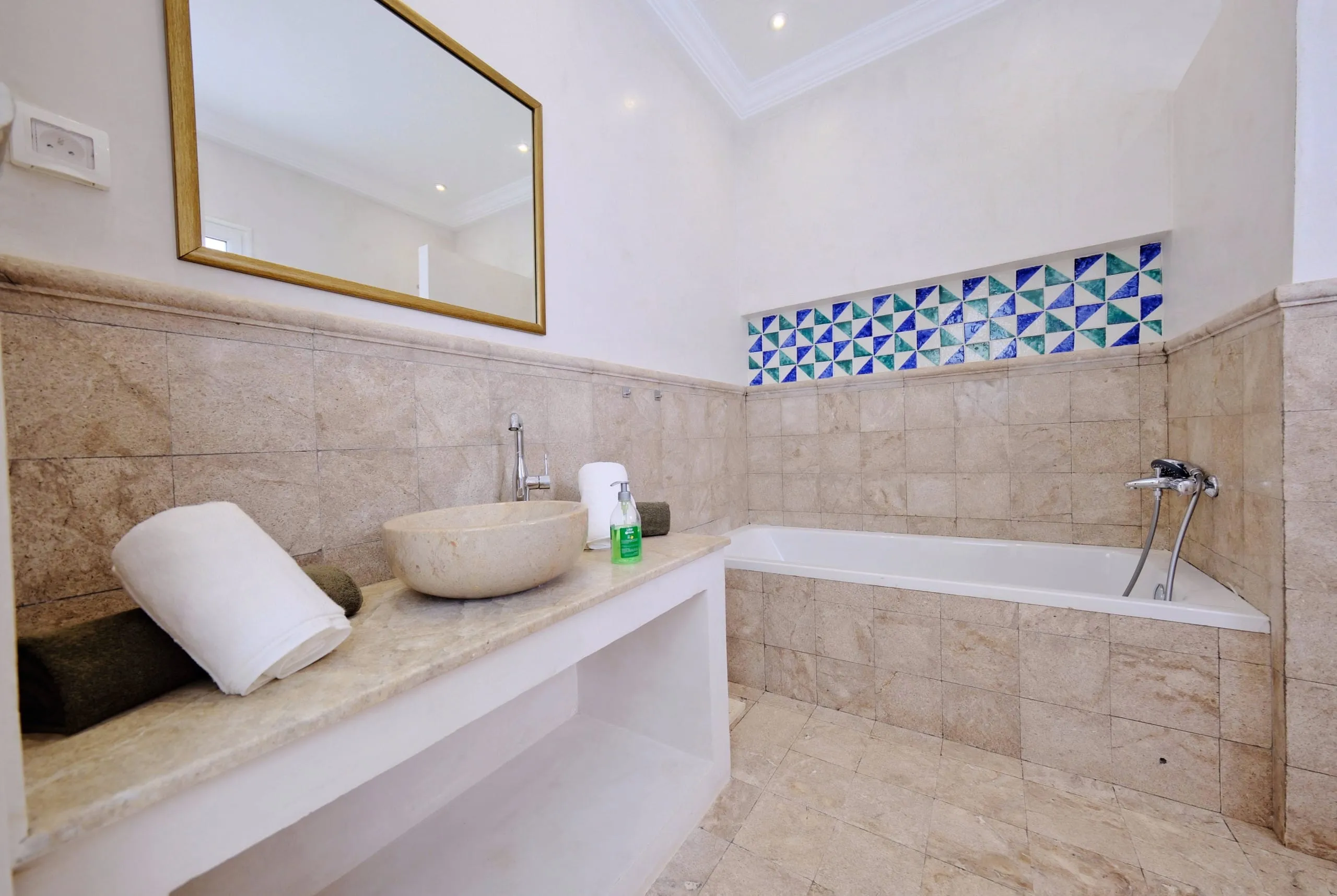 A bathroom in stone and zellige tiles