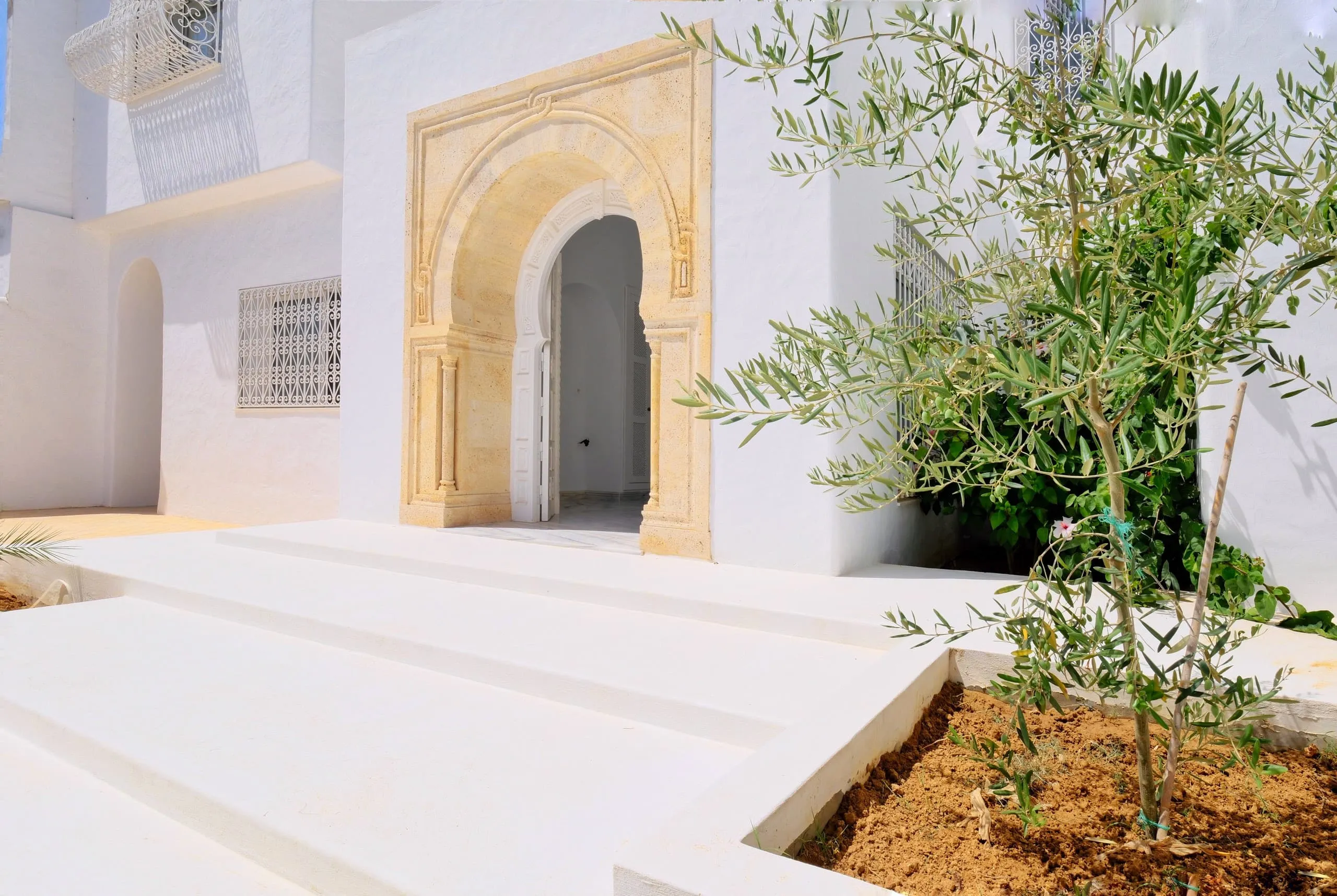 Carved Dar Chaâbane stone door frame at Villa Carthago