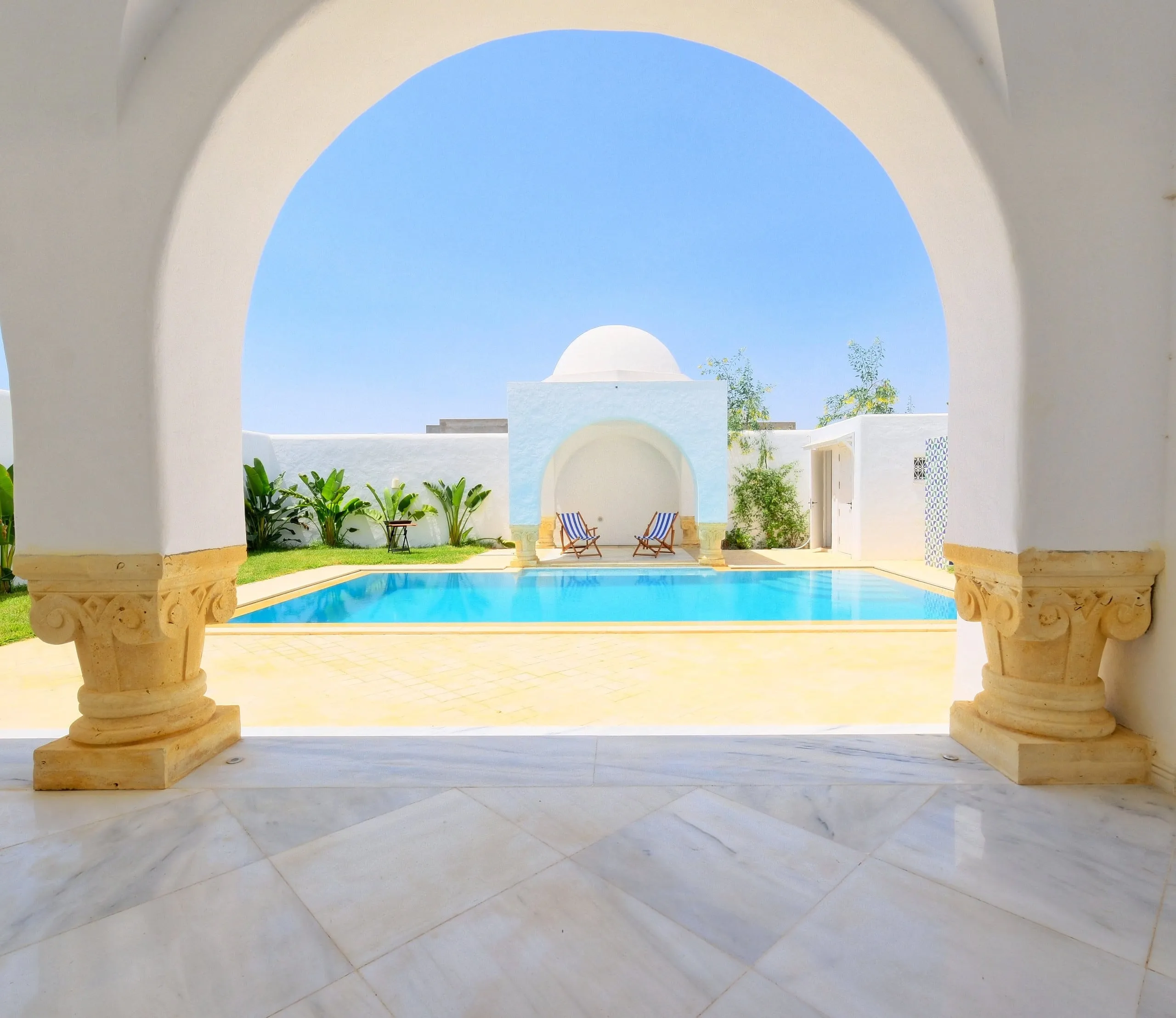 The pool seen through the terrace arches