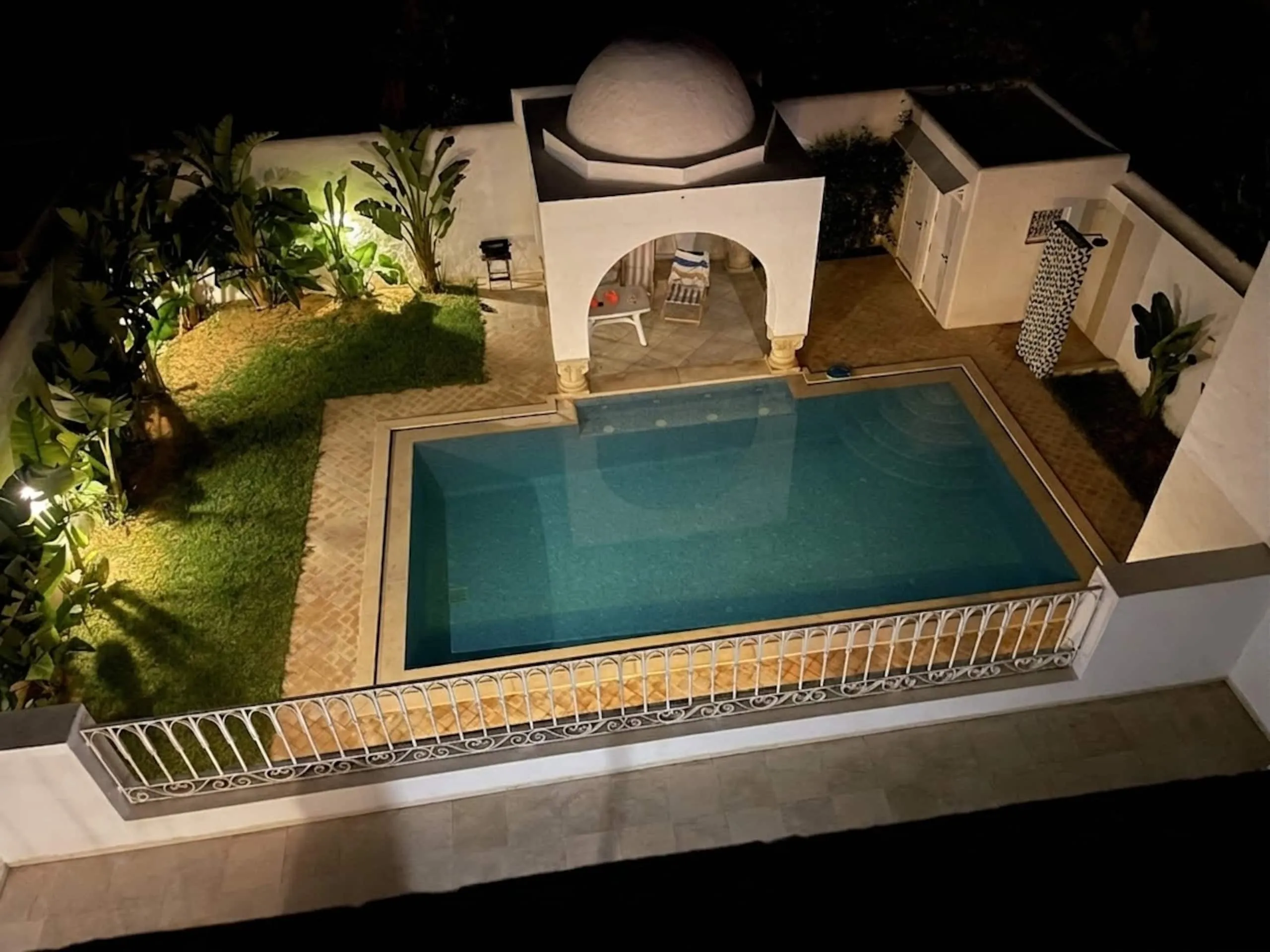 Night view over the pool and pavilion